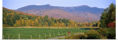 Woman cycling on a road, Stowe, Vermont