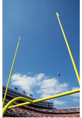 American football flying through the goalposts