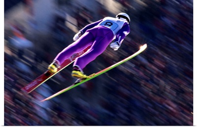 Blurred action of ski jumper flying through the air