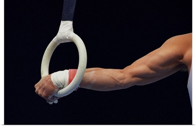 Detail of the hands of male gymnast grabbing the ring