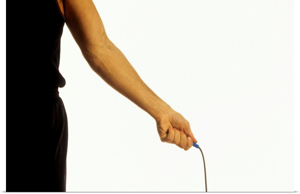 Detail of young man exercising with jump rope