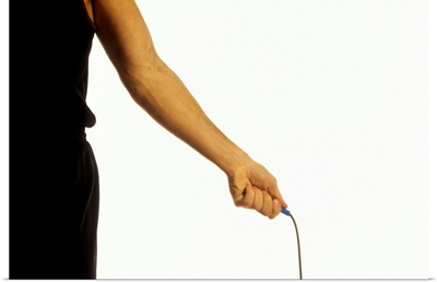 Detail of young man exercising with jump rope