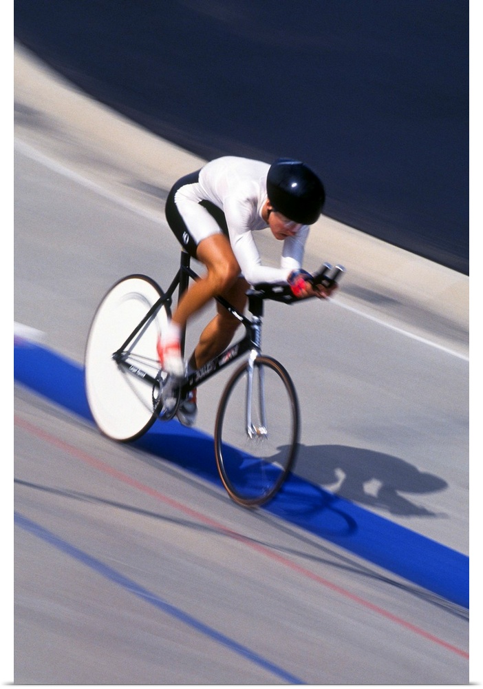 Female cyclist racing on the velodrome track