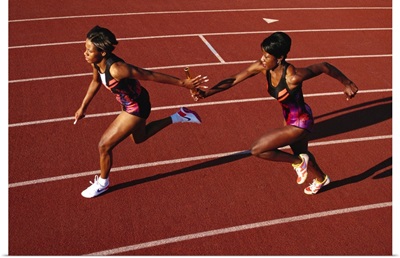 Female runner competing in a relay track race