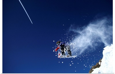 Male snowboarder flying through the air