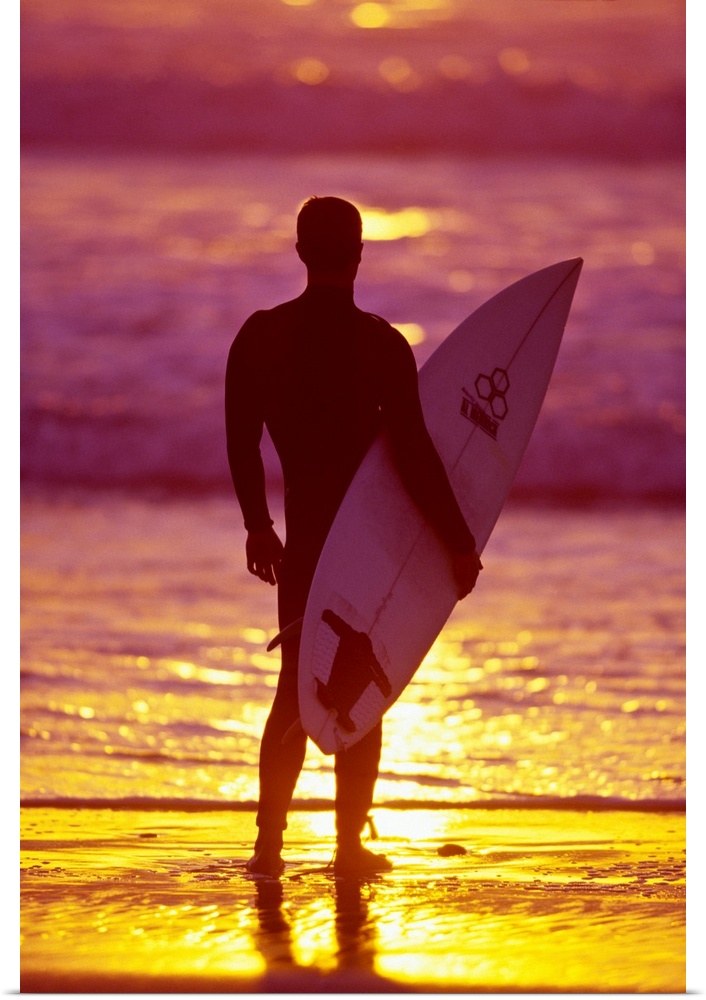Male surfer on a beach in San Diego, CA