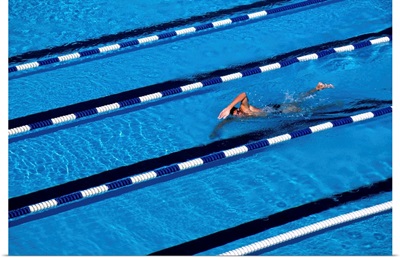 Male swimmer training doing laps in the pool