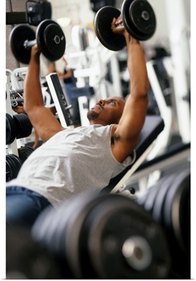 Male working out with weights in a health club