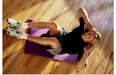 Man engaged in sit up exercise  in gym