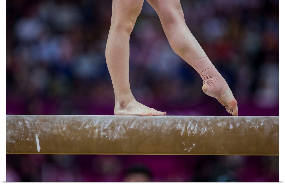 Detail of gymnast  preforming on the balance beam during the women's gymnastics team finals at the 2012 Olympic Summer Gam...