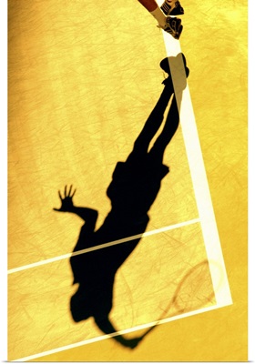 Shadow of tennis player serving