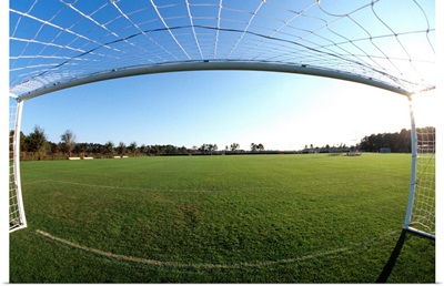 View of soccer field through goal