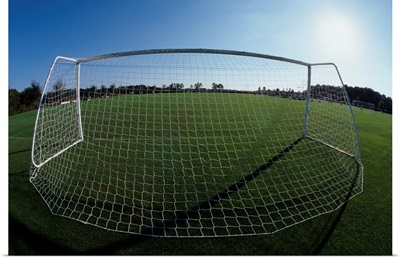 View of soccer field through goal