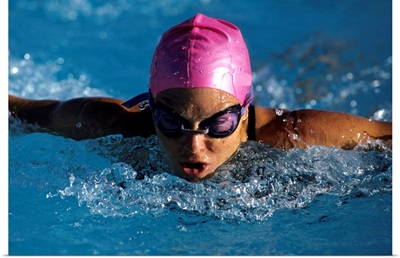 Woman in action during a butterfly swimming race.