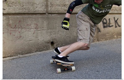 Young male skateboarder on urban street