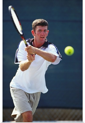 Young male tennis player in action