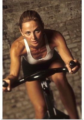 Young woman exercising on a stationary bike.
