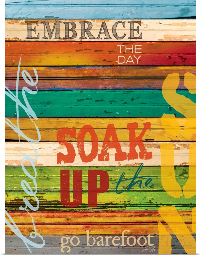 Typography home decor art, with text in different fonts against a colorful wooden surface.