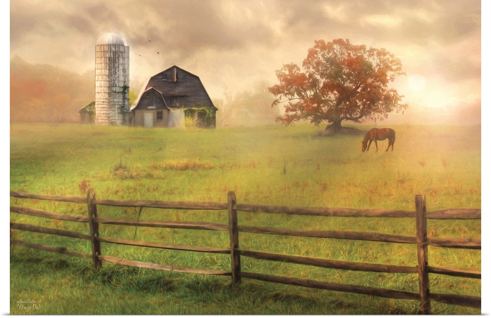 A horse in a field near a barn with a silo and a wooden fence.