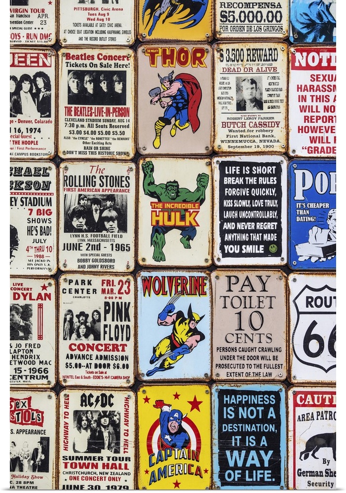 Souvenir metal signs for sale in London, featuring superheroes, sarcastic sayings, and popular music artists.