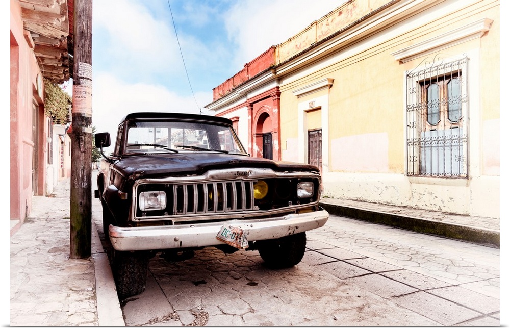 Washed out photograph of an old black Jeep parked on the side of a colorful street in Mexico. From the Viva Mexico Collect...