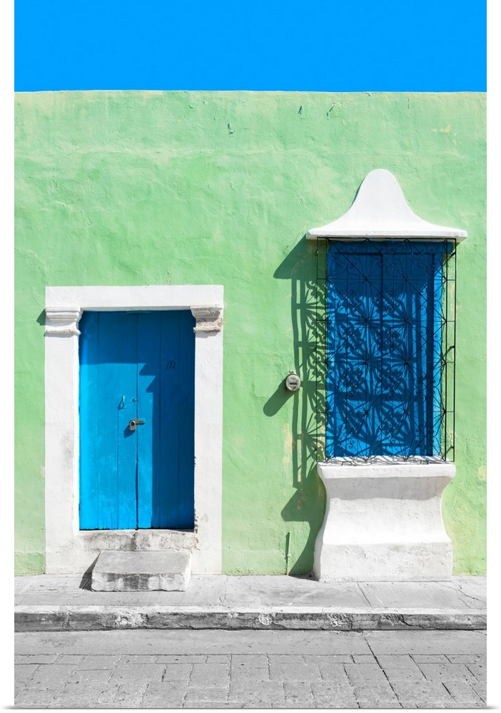 Photograph of a green exterior wall with a blue door and window in Campeche, Mexico. From the Viva Mexico Collection.