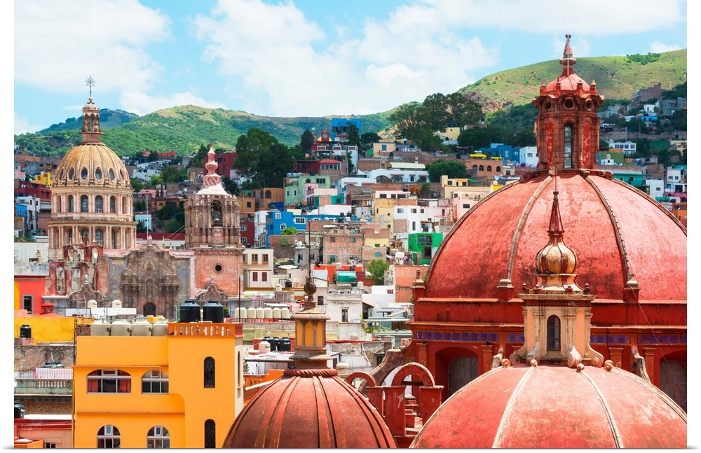 Cityscape photograph of colorful buildings and several church domes in Guanajuato, Mexico. From the Viva Mexico Collection.