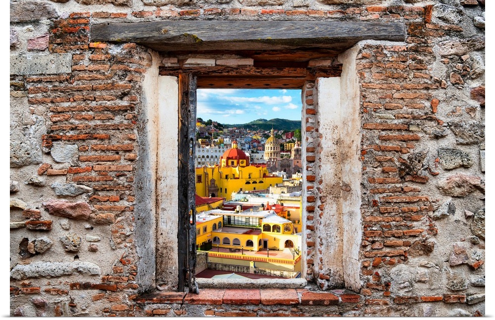 View of the colorful city of Guanajuato, highlighting the church domes, framed through a stony, brick window. From the Viv...