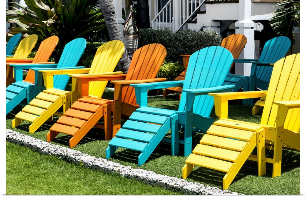 A collection of brightly painted Adirondack chairs.