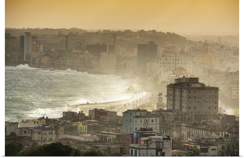 Aerial photograph of the ocean meeting the city of Havana at sunrise.