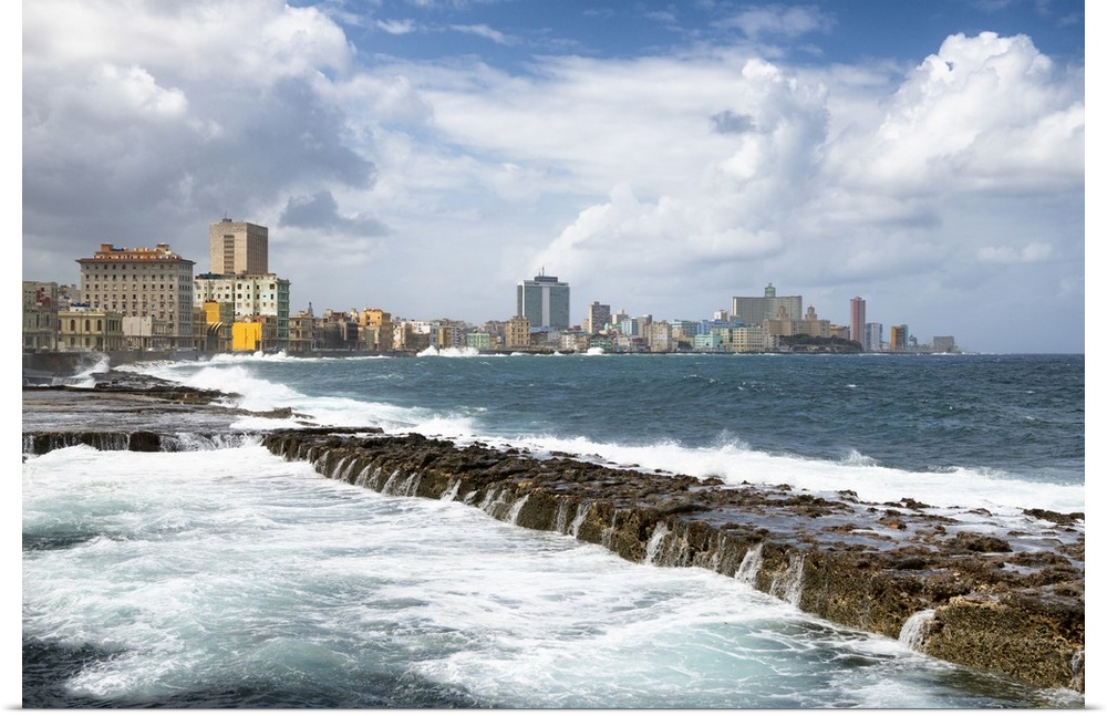 Photograph of Malecon seawall with the city of Havana in the background.
