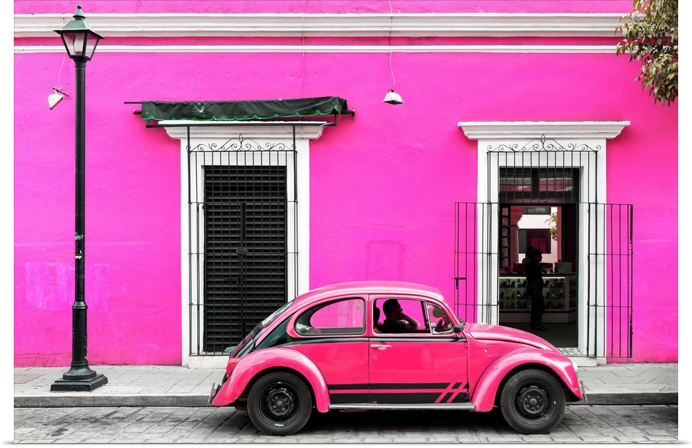 Photograph of a classic pink Volkswagen Beetle in front of a pink building, Mexico. From the Viva Mexico Collection.