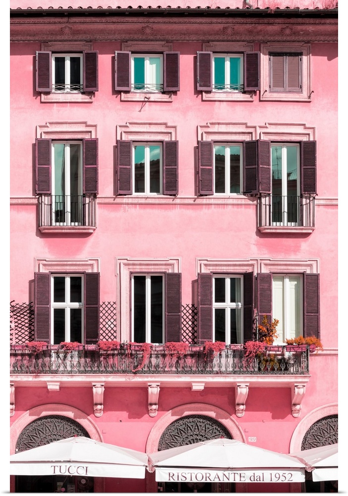 It's a pink facade of a building in the city of Rome in Italy.