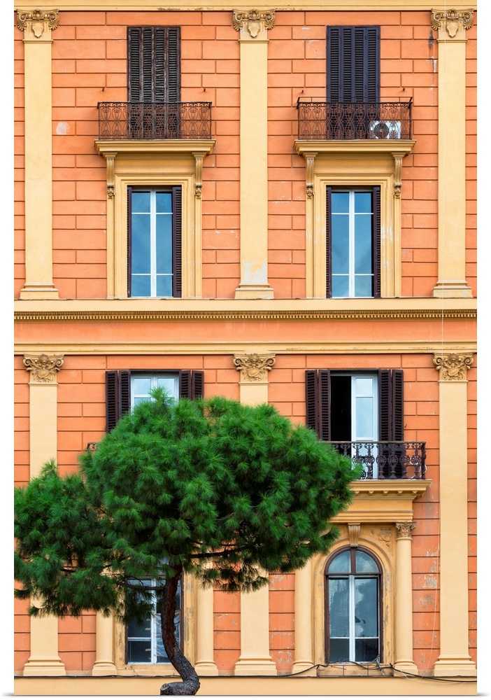 It's a orange facade of a building in the city of Rome in Italy.
