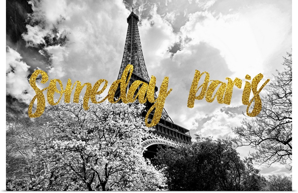 Black and white photograph of the Eiffel Tower surrounded by treetops with the phrase "Someday Paris" written on top in go...