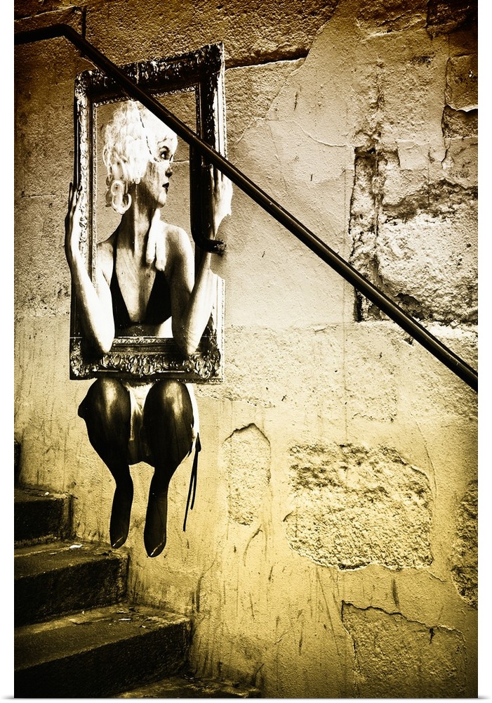 Street art of a woman in a picture frame on the wall of a building in Paris, France.