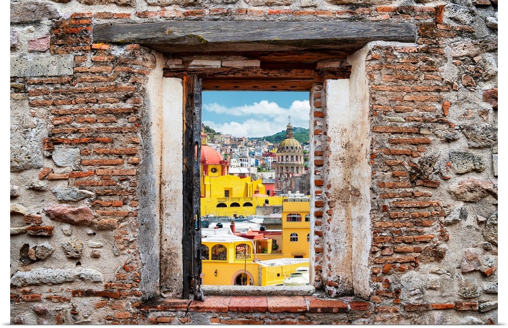 View of the colorful city of Guanajuato framed through a stony, brick window. From the Viva Mexico Window View.