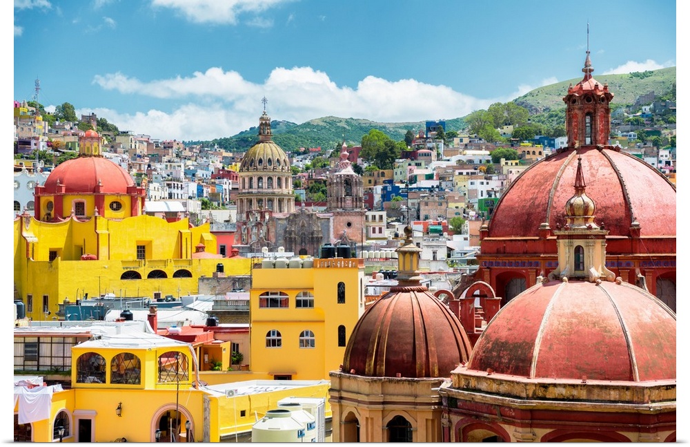 Photograph of a cityscape in Guanajuato, Mexico, highlighting the colorful buildings and church domes. From the Viva Mexic...
