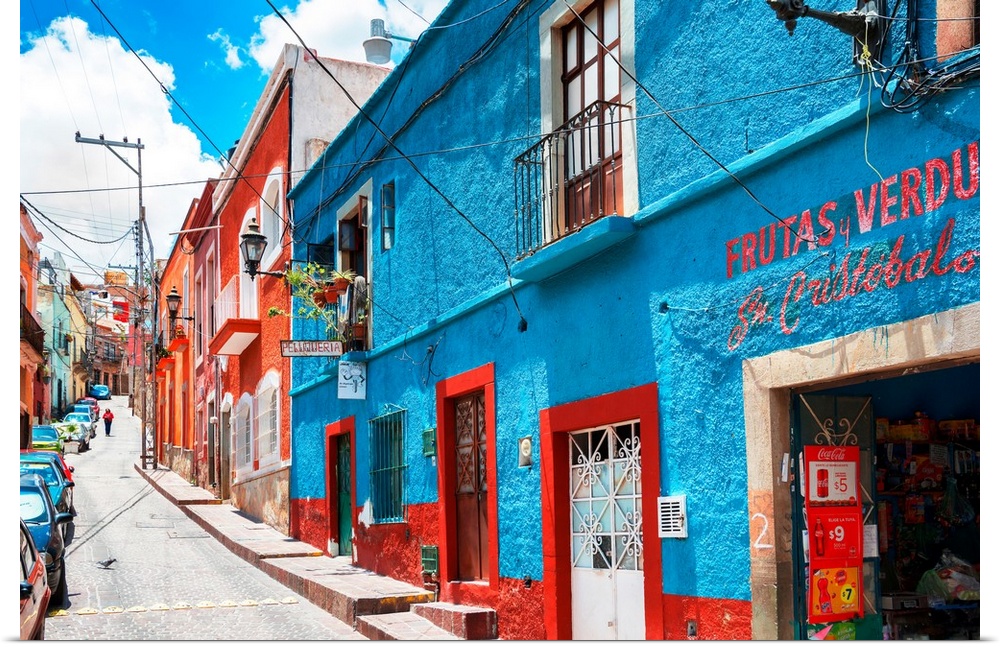 Colorful streetscape photograph in Guanajuato, Mexico with bright blue and red buildings. From the Viva Mexico Collection.