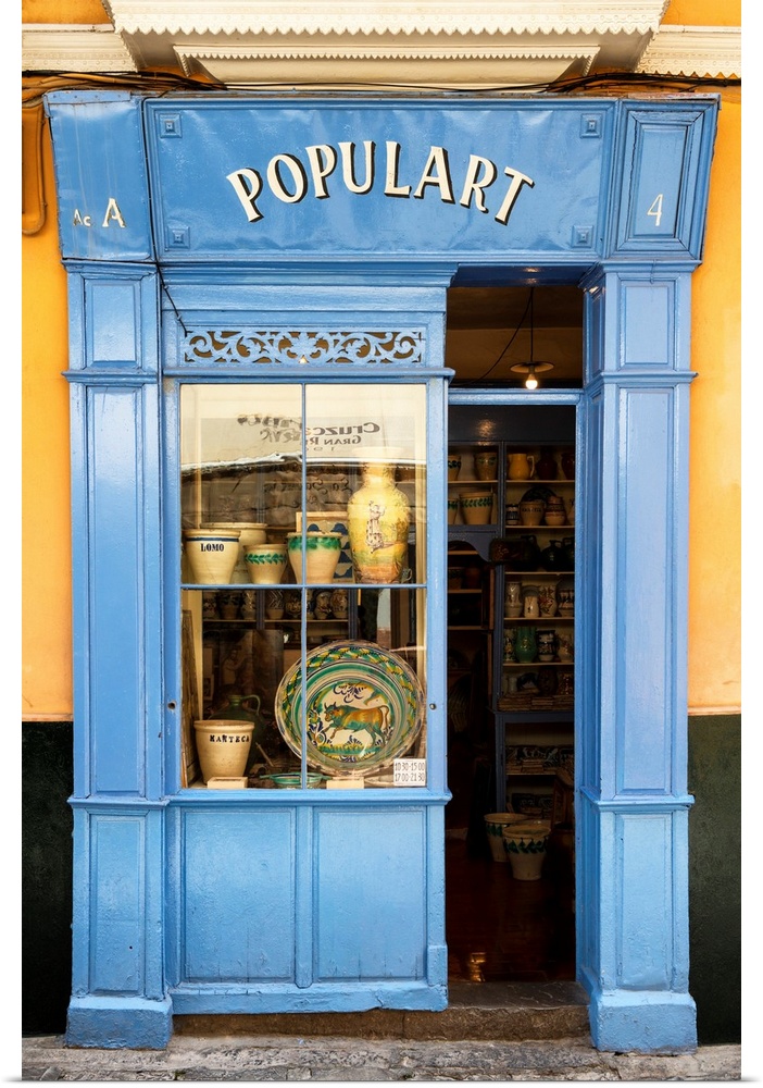 It's an old colorful facade of a shop in the streets of Seville in Spain.