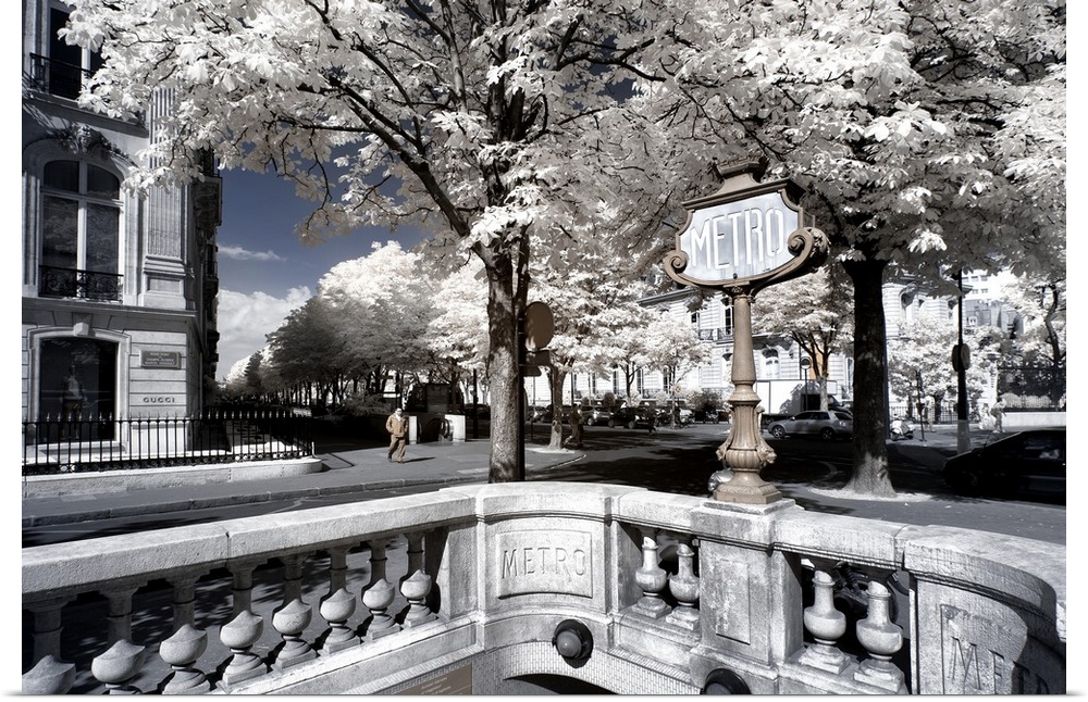 Sign for the Metro in a park in Paris, made in infrared mode in summer. The vegetation is white and rendering of the sky i...