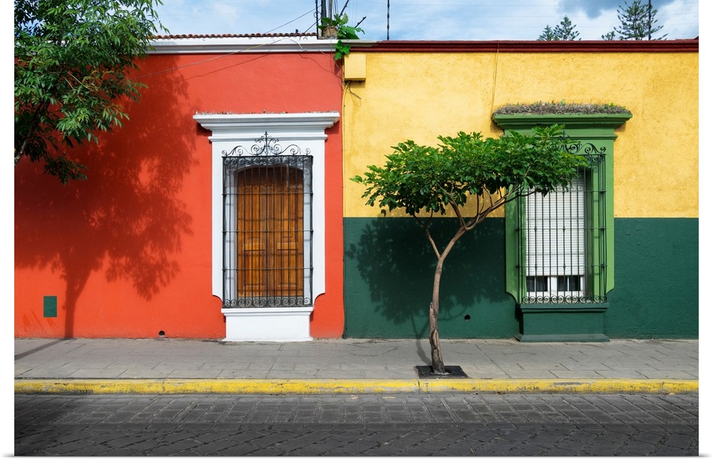 Photograph of colorful facades in Mexico in red, yellow, and green. From the Viva Mexico Collection.