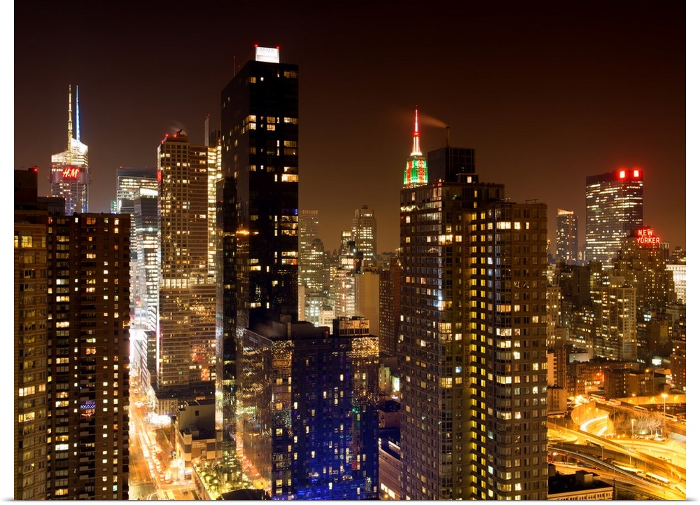 A fine art photograph of New York city's Manhattan lit up at night.