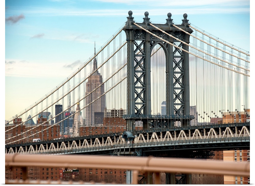 A photograph of the Manhattan bridge, with the Empire state building in the background.