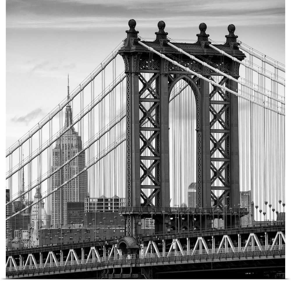 A black and white photograph of the Manhattan bridge, with the Empire state building in the background.