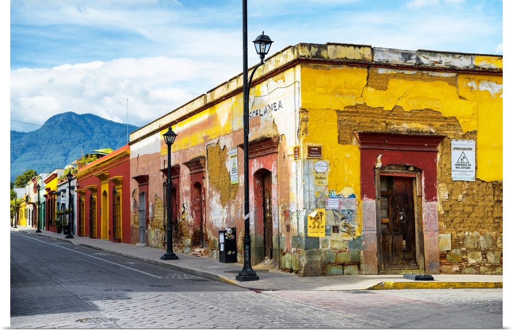 Photograph of a bright city street in Oaxaca, Mexico, with a view of mountains in the background. From the Viva Mexico Col...