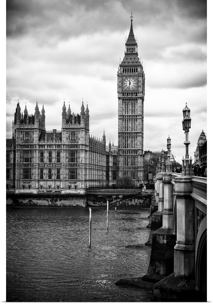 Black and white photo of Big Ben overlooking the river Thames under an overcast sky.