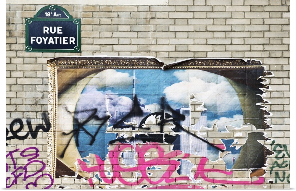 Graffiti on a poster and brick wall in Montmartre, the 18th municipal arrondissement in Paris.