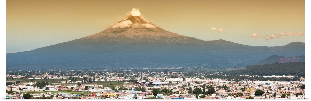 Panoramic aerial photograph of the Popocatepetl Volcano in Puebla, Mexico, with a bird's eye view of the city underneath. ...