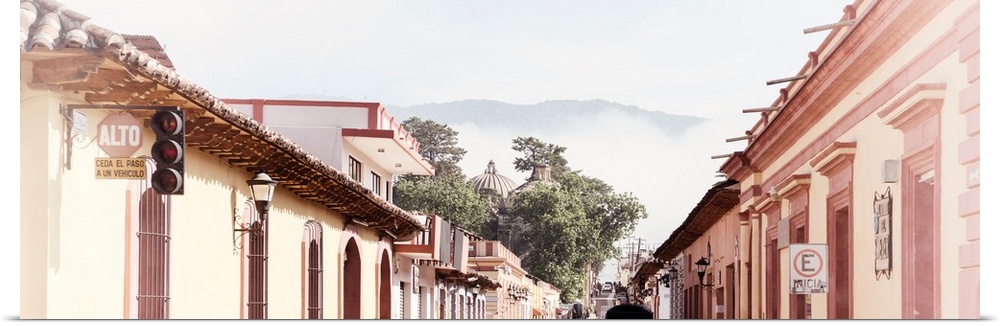 Washed out panoramic photograph of a streetscape at San Cristobal de Las Casas in Chiapas, Mexico, with heavy fog in the b...